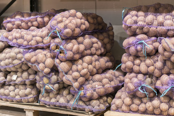 Bags with potatoes. potatoes in bags close-up, a lot of potatoes, a store or market