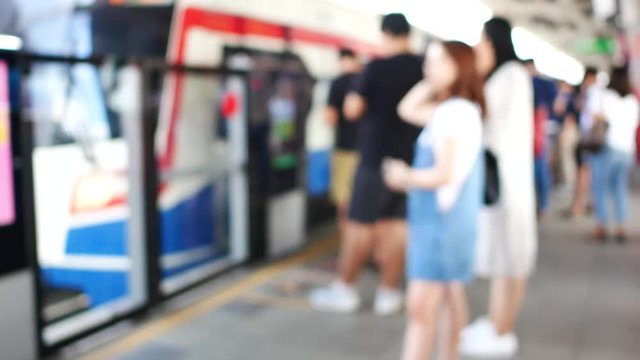 Blur of passenger are waiting at sky train station based in center of Bangkok Thailand 