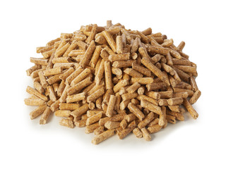 Heap of compressed wood pellets on white