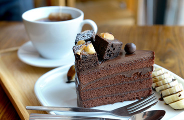 Chocolate cake on dish at coffeeshop table