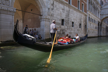 Obraz na płótnie Canvas VENICE, ITALY - AUGUST 29, 2018: Traditional narrow canal street with gondolas and old houses in Venice, Italy. 