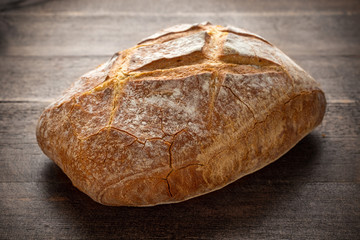 Fresh baked brown Bread on wooden table