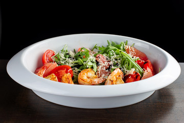 Fresh salad plate with shrimp, tomato and mixed greens.