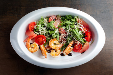 Fresh salad plate with shrimp, tomato and mixed greens.
