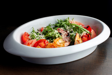 Fresh salad plate with shrimp, tomato and mixed greens.