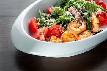 Fresh salad plate with shrimp, tomato and mixed greens.