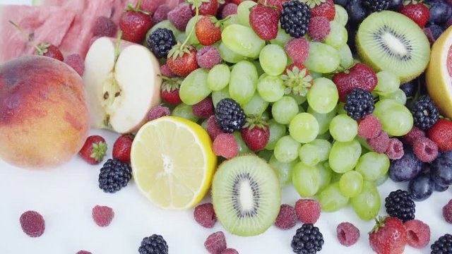 Beautiful mixed berries and fruit on white background. Close up healthy food. 4K