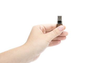 flash drive in woman's hand on white background. Female's hand holding flash drive.