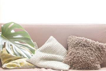 Fototapeta na wymiar interior design with a sofa and a variety of pillows