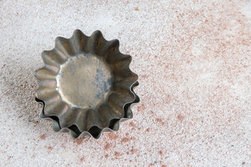 Vintage metal molds on a concrete background.
