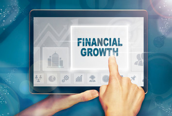 A hand selecting a Financial Growth business concept on a clear screen with a colorful blurred...