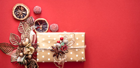 Christmas concept, gift box with decor on red background