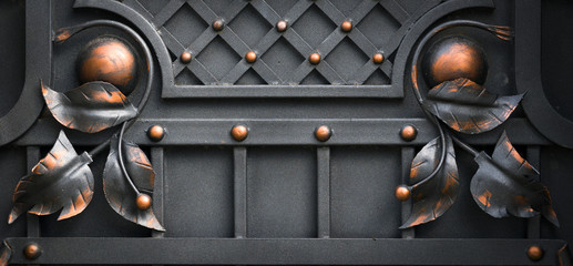 Wrought-iron gates, ornamental forging, forged elements close-up.