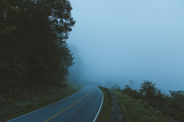 A windy road fades off into the distance in Shenandoah National Park, VA as it's engulfed by clouds.