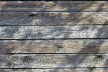 wooden background with shadow from leaves