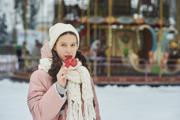 Girl in pink coat in snow Park. Girl plays in winter Park. Adorable child walking in snow winter forest