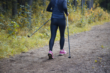 woman practicing nordic walking in nature
