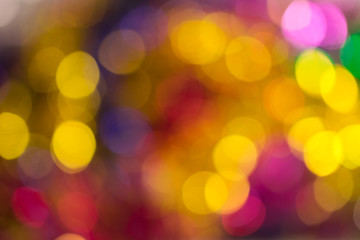 Fototapeta premium Abstract bokeh light. Christmas mood. Orange, pink, golden and blue lights.
