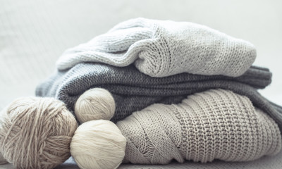 Fototapeta na wymiar home hobbies, cozy knitted sweaters, wooden background