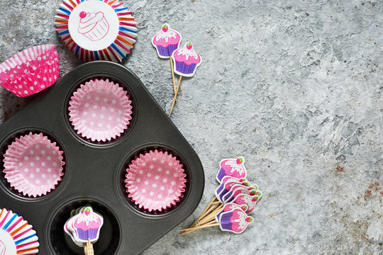 Concrete food background. Form for the preparation of muffins (capcicles). Decoration for capkake.