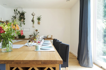 Fresh summer breakfast in Mediterranean style kitchen. Bright and sunny space with a lot of herbs and plants.