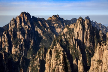 Huangshan China National Park - Anhui Province, Chinese Mountain Peak. Towering Pillars of Yellow Granite, Mountains with Canyon, Exotic Pine Trees and Forest, Jagged Cliffs, UNESCO World Heritage