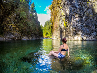 Young Beautiful Woman Swims in Crystal Clear Green River Mermaid
