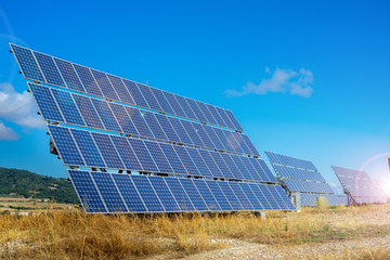 Solar farm. Solar power station with blue sky. Solar panels on the hill. Concept eco life. Concept...