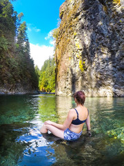 Young Beautiful Woman Swims in Crystal Clear Green River Mermaid