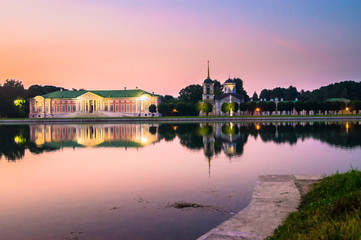 Fototapeta premium Admirable pink sunset sky over the architectural ensemble of the State reserve museum Kuskovo, former aristocratic summer country estate of the russian nobility of the 18th century. Moscow. Russia.