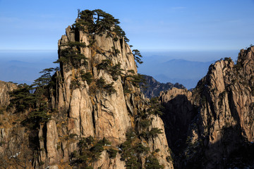 Fototapeta na wymiar Huangshan China National Park - Anhui Province, Chinese Mountain Peak. Sea of Fog, Yellow Granite Mountains with Canyon, Exotic Pine Trees and Forest, Jagged Cliffs, UNESCO World Heritage Site
