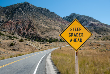 Steep Grades Warning Sign:  A sign warns of a steep climb ahead on a road leading into the Big Horn Mountains of northeastern Wyoming