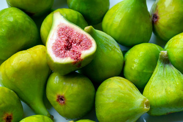 Fruits of fig tree with leaves on white background/ Fresh figs with leaves on rustic wooden table/ Healthy lifestyle concept / Healthy food concept
