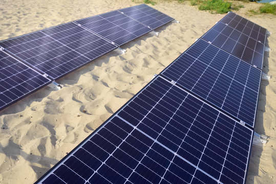 Solar panel being charged on the beach.