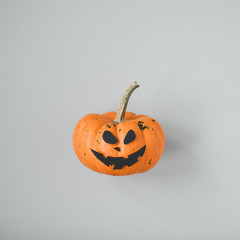 Funny Halloween pumpkin Jack o Lantern on gray background