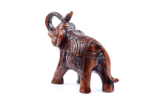 Brown Engraved pattern gold elephant made of resin like wooden carving with white ivory. Stand on white background, Isolated, Art Model Thai Crafts, For decoration Like in the spa.