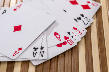Fan of playing cards on wooden background