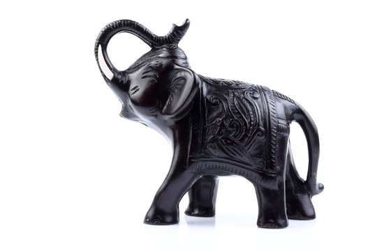 Black Engraved pattern gold elephant made of resin like wooden carving with white ivory. Stand on white background, Isolated, Art Model Thai Crafts, For decoration Like in the spa.