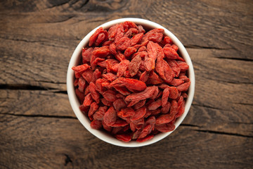 Dried fruits of Goji berries or wolfberry on rustic wooden table