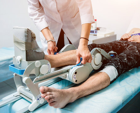 Patient on CPM (continuous passive range of motion) machines.