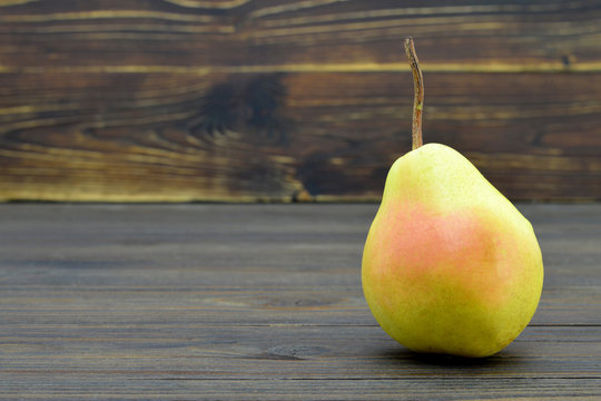 Ripe pear on wooden background