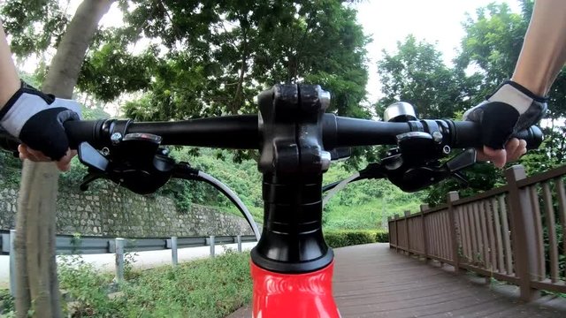 Riding bike on bicycle path in park, View from first person perspective POV - Point of view front  by action camera