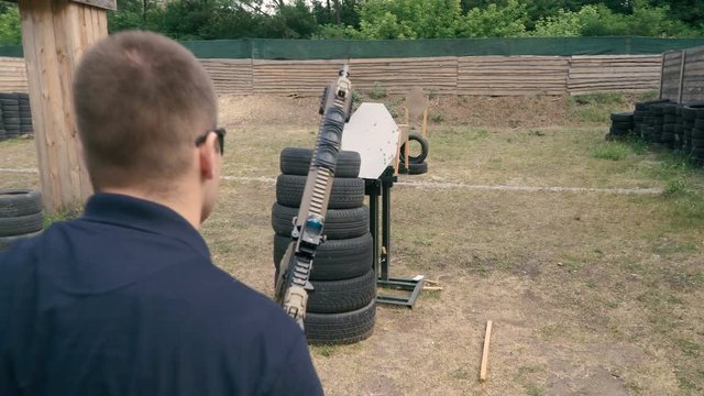 Shooting in a dash. The guy shoots in a dash with a semi-automatic rifle