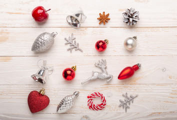 Silver and red christmas gifts on white wooden background. Top view