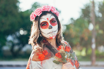 Obraz premium Closeup portrait of Calavera Catrina. Young woman with sugar skull makeup. Dia de los muertos. Day of The Dead. Halloween.