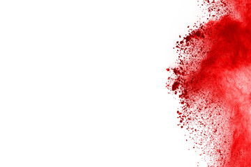 Freeze motion of red powder exploding, isolated on white background. Abstract design of red dust cloud. Particles explosion screen saver, wallpaper