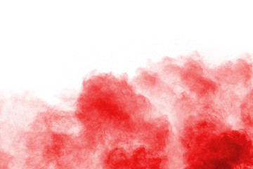 Freeze motion of red powder exploding, isolated on white background. Abstract design of red dust cloud. Particles explosion screen saver, wallpaper