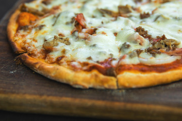 Delicious pizza with mozzarella cheese, minced meat and bacon