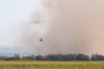 Joint firefighting by airplane and helicopter, on the floodplains of the Anapka River, Anapa, Russia