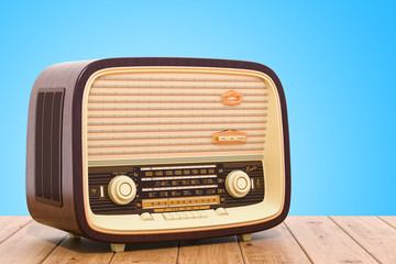 Vintage radio receiver on the wooden table. 3D rendering